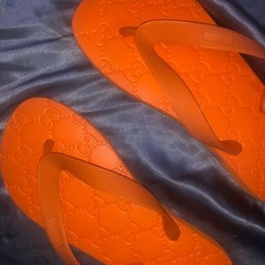 Orange Gucci flip flops